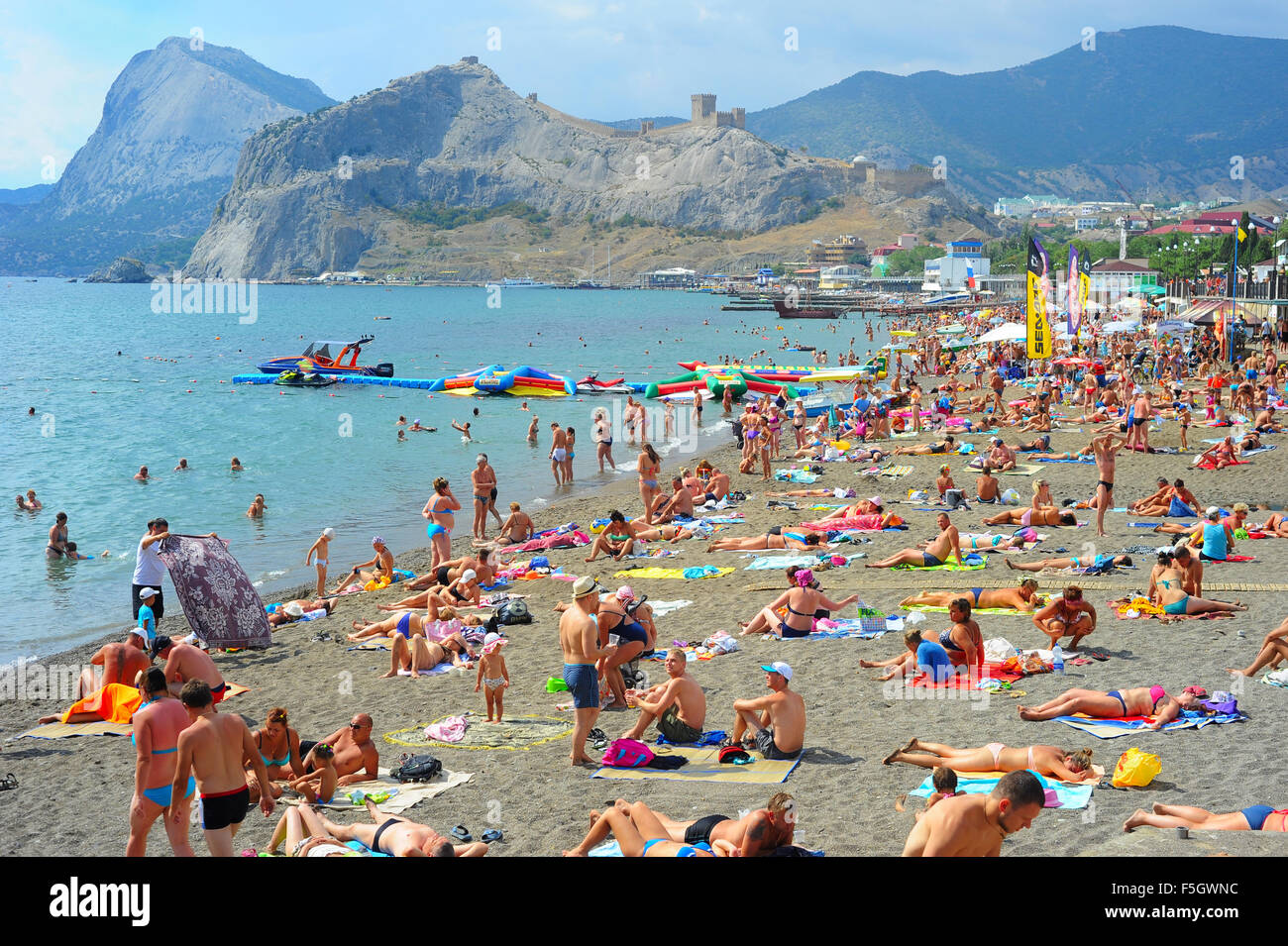 People at a sea beach in Sudak. Crimea, Russia Stock Photo