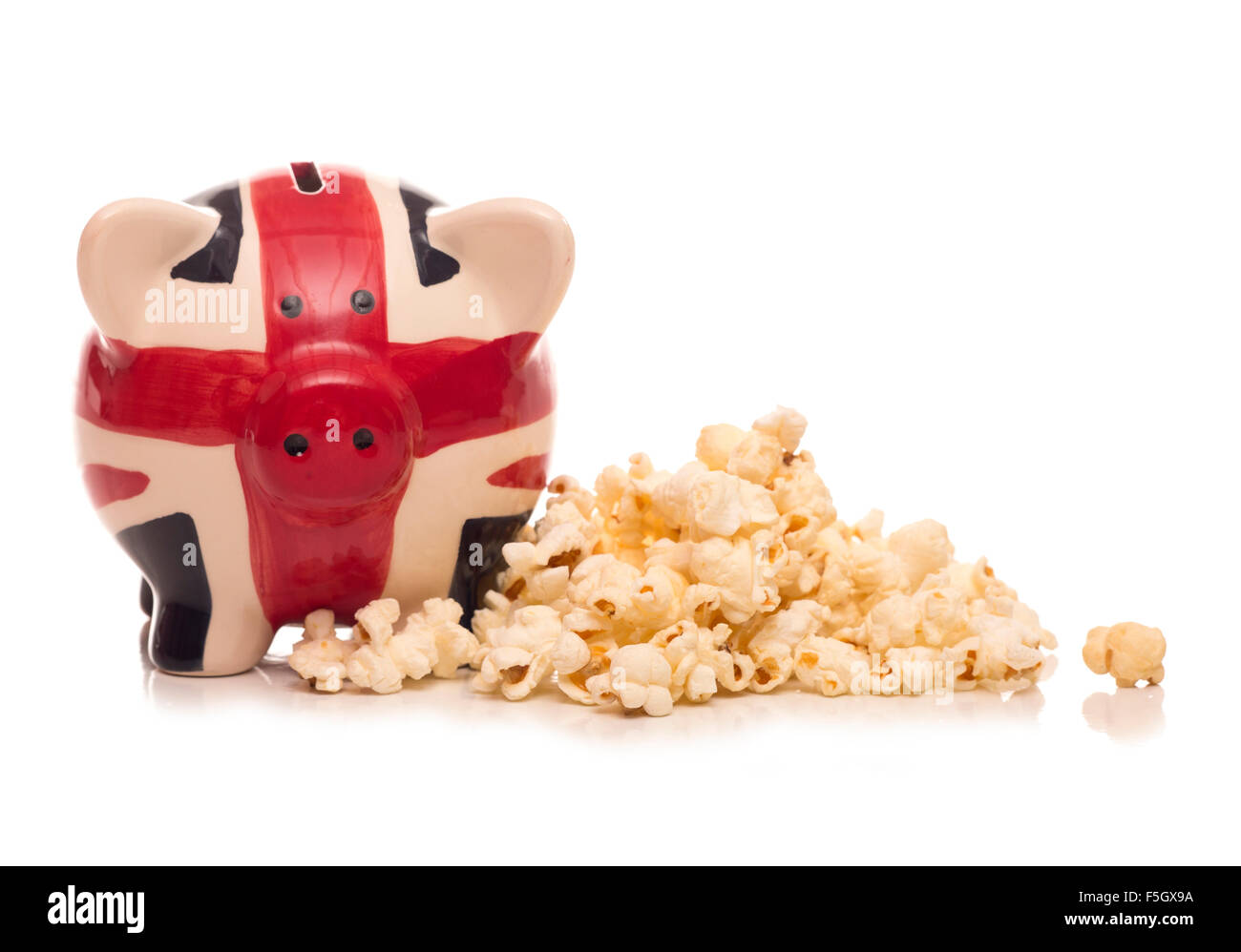 piggy bank and popcorn studio cutout Stock Photo