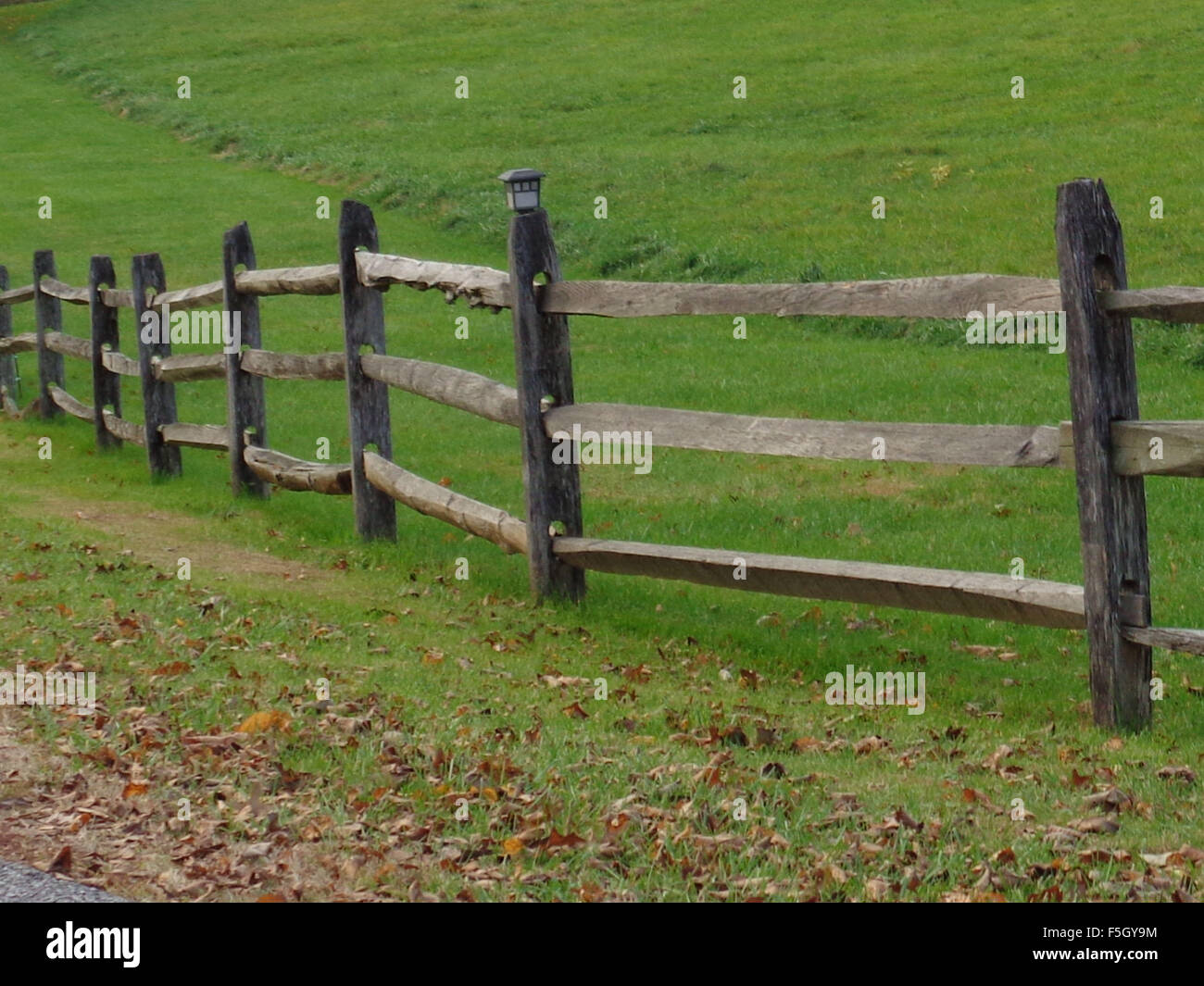 Old wooden fence along a roadway between the lane and pasture Stock ...