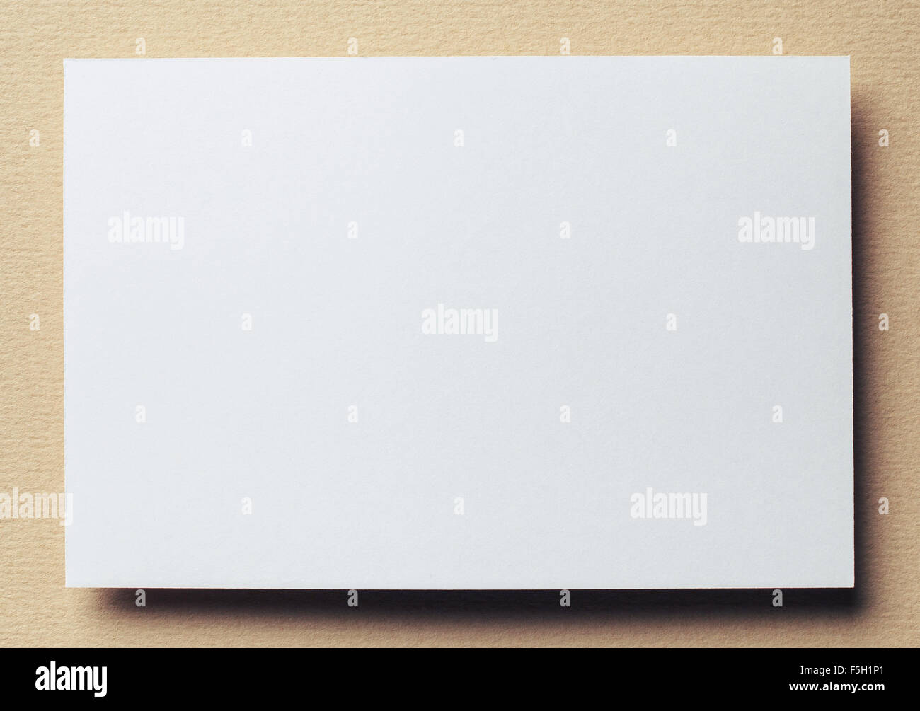 paper card on beige background Stock Photo - Alamy