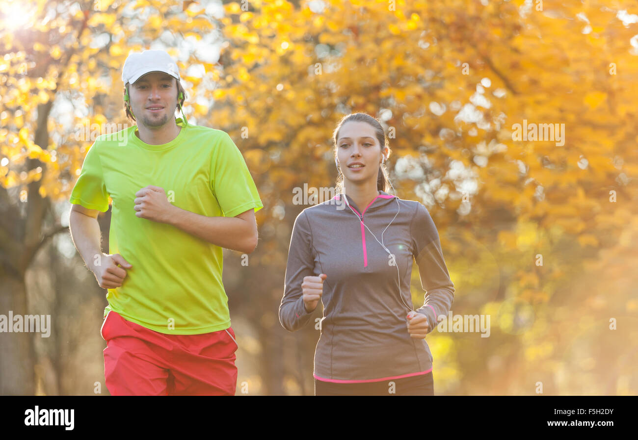 Young couple running in autumn season Stock Photo