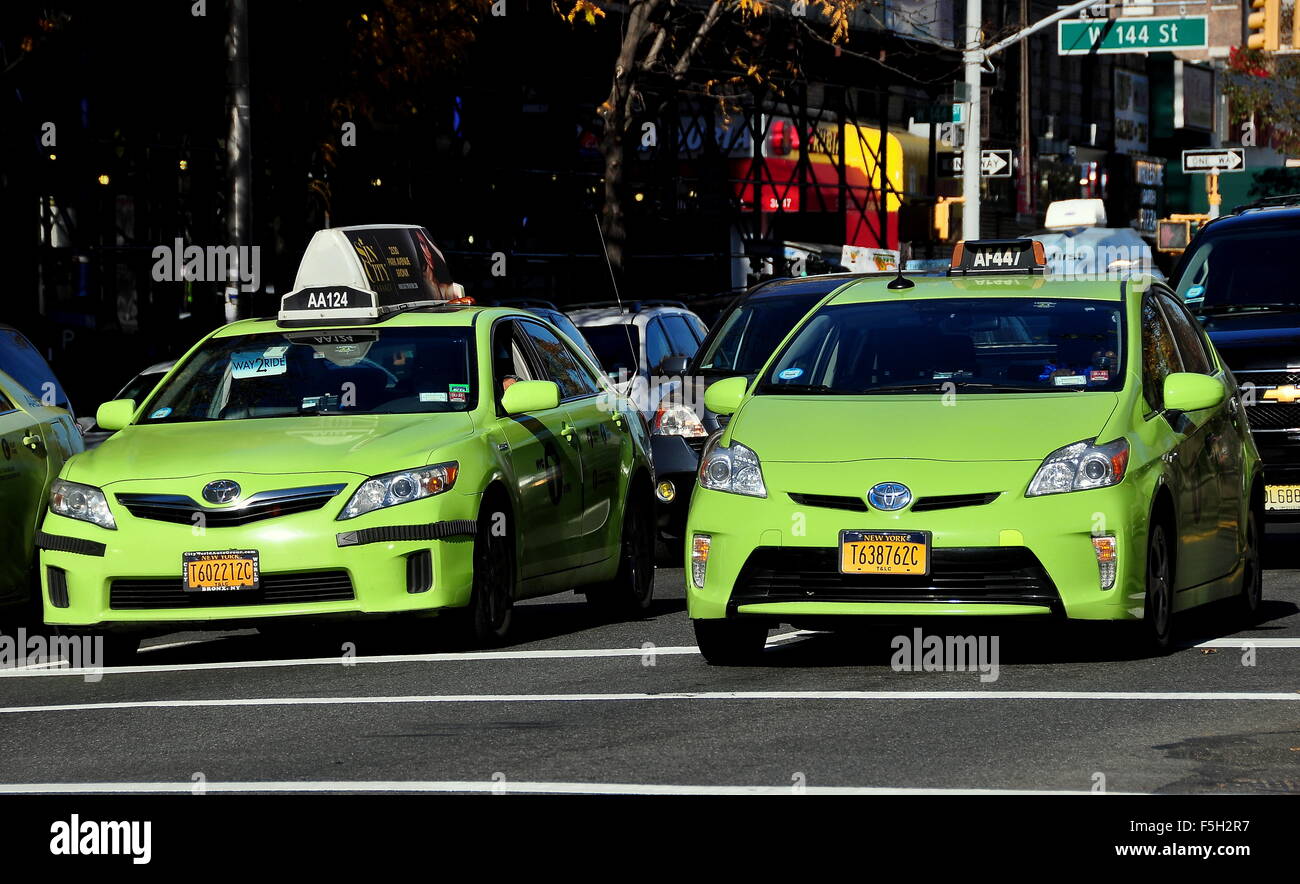 New York City Two NYC green Toyota taxis waiting at a traffic light on