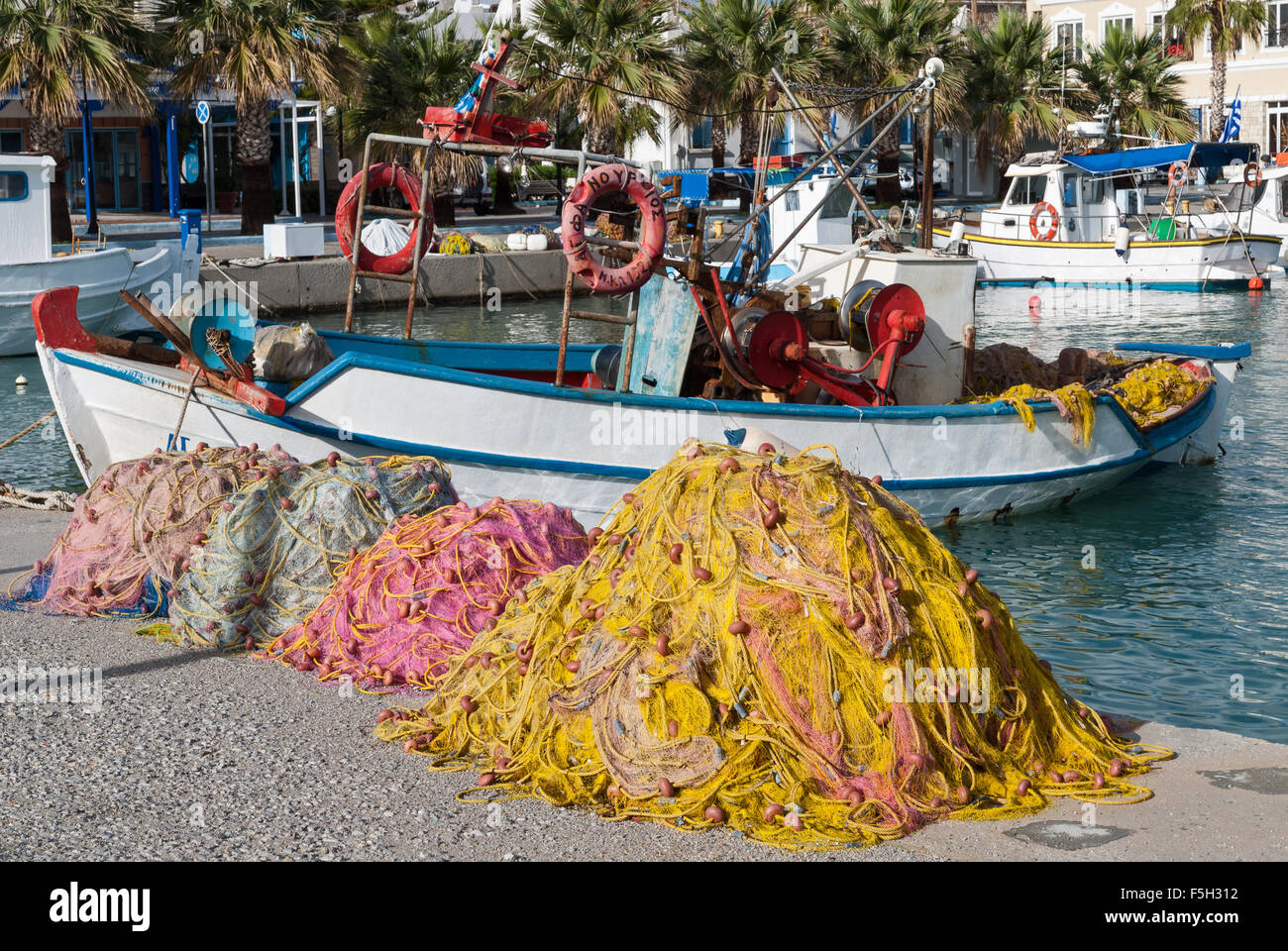 Traditional wooden boats and fishing nets in the harbor on October 12, 2013 in Kos island, Greece. Stock Photo