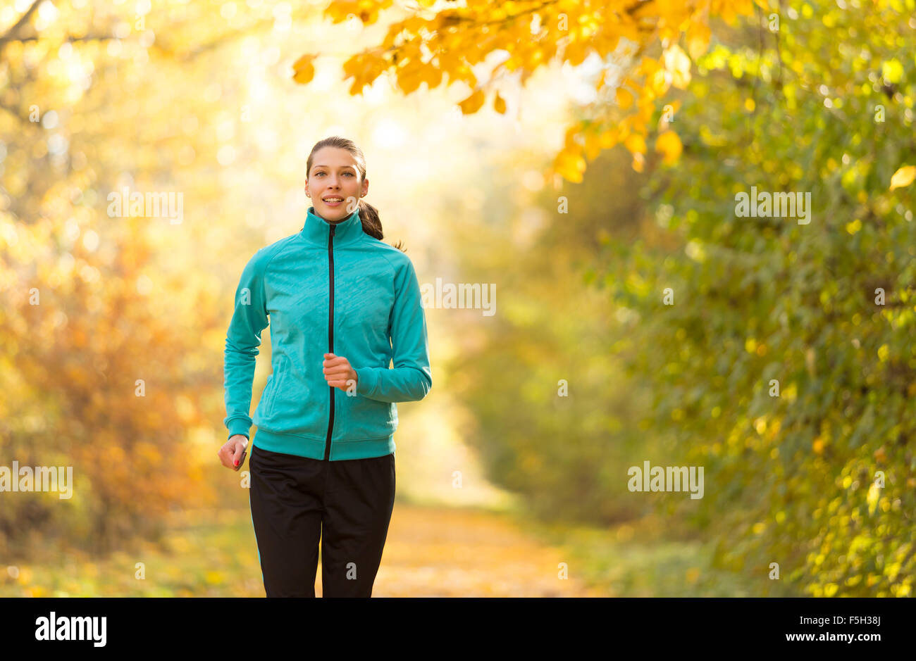 Female fitness model training outside and running Stock Photo - Alamy