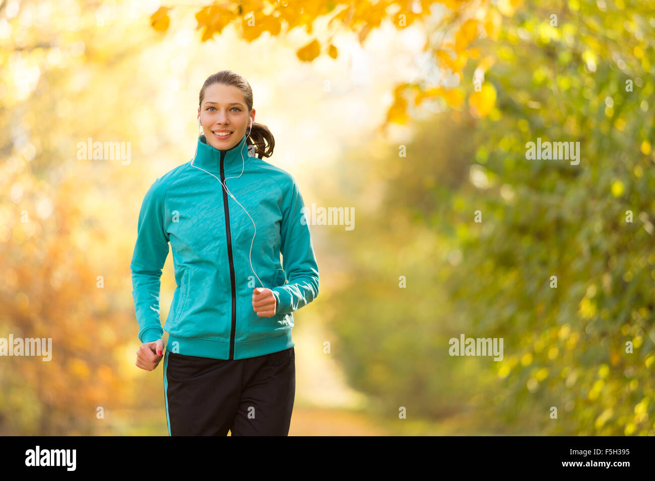 Female fitness model training outside and running Stock Photo - Alamy