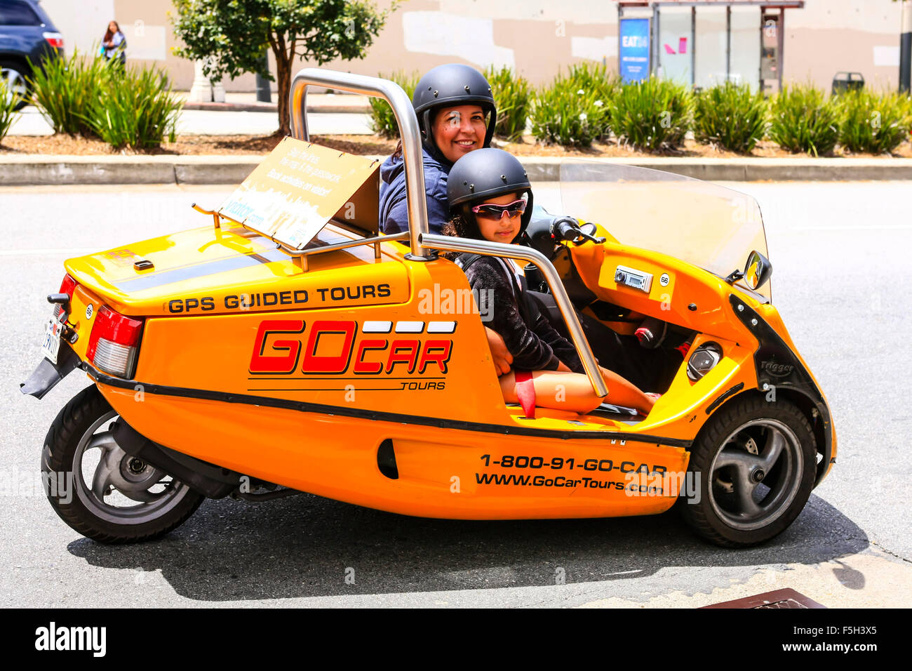 A GPS Guided Go Car with helmeted occupants touring San Francisco Stock Photo
