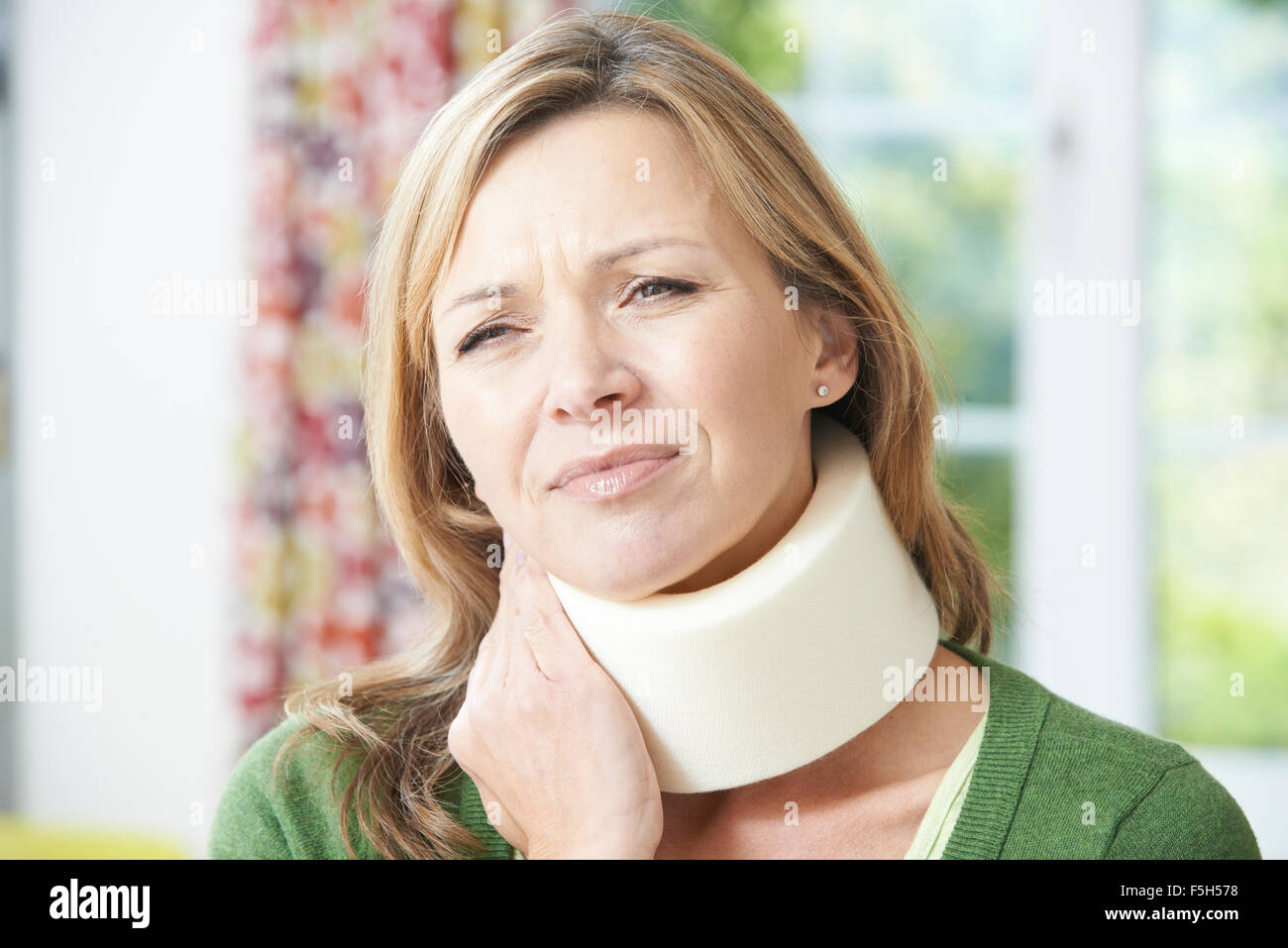 Woman Wearing Surgical Collar In Pain Stock Photo - Alamy