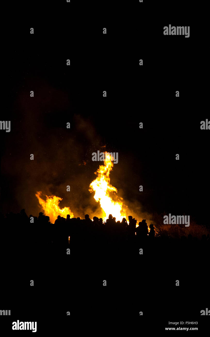 People stood around a bonfire - portrait orientation Stock Photo