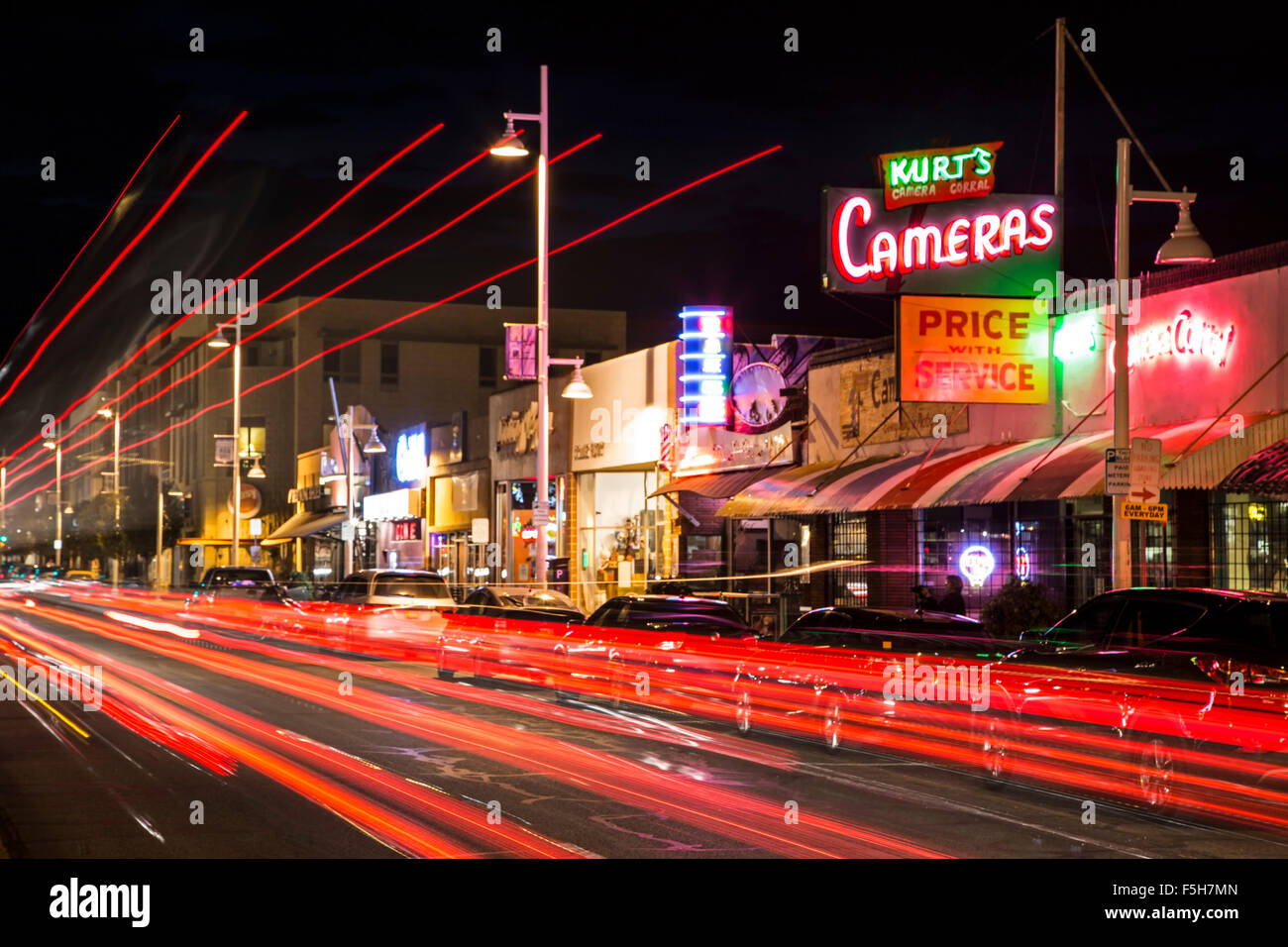 Kurt's Camera Corral neon sign and light streaks on Central Avenue (formerly Route 66), Nob Hill, Albuquerque, New Mexico USA Stock Photo