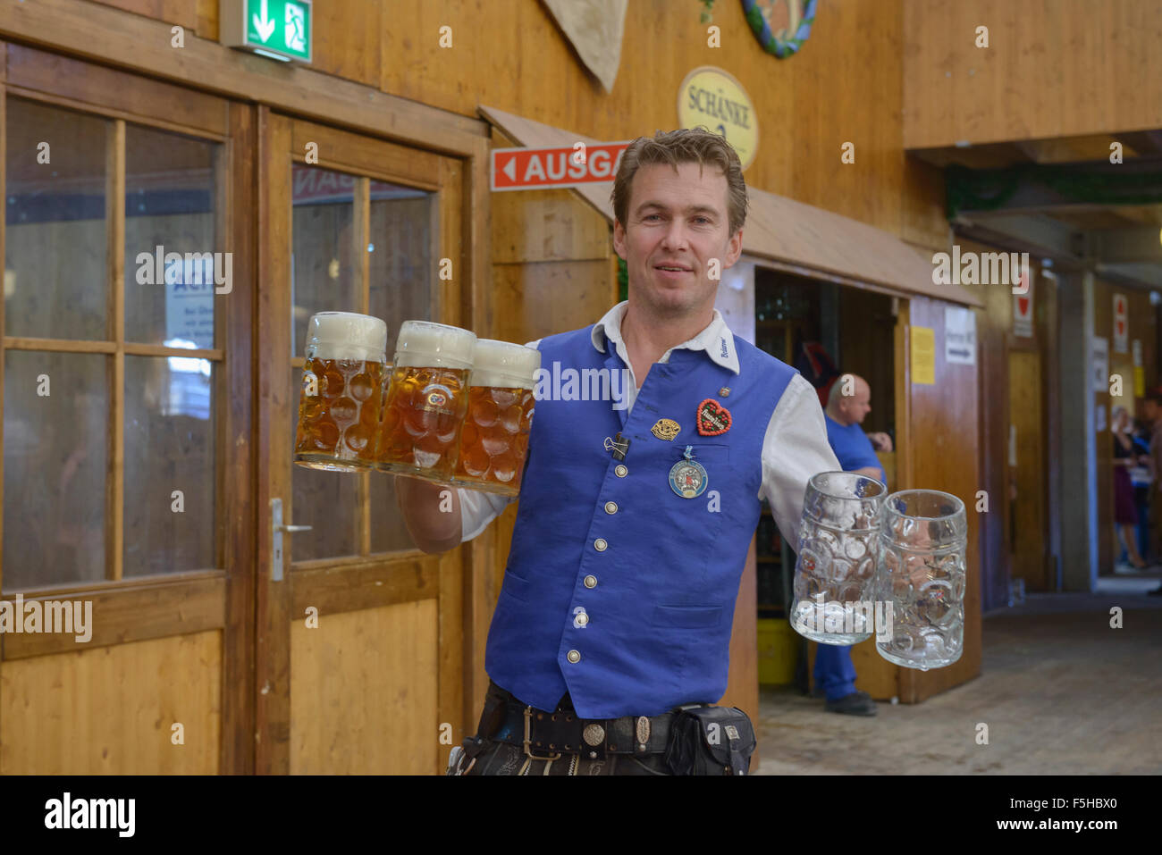 Waiter carrying masses of beer at Oktoberfest in Munich, Germany Stock Photo