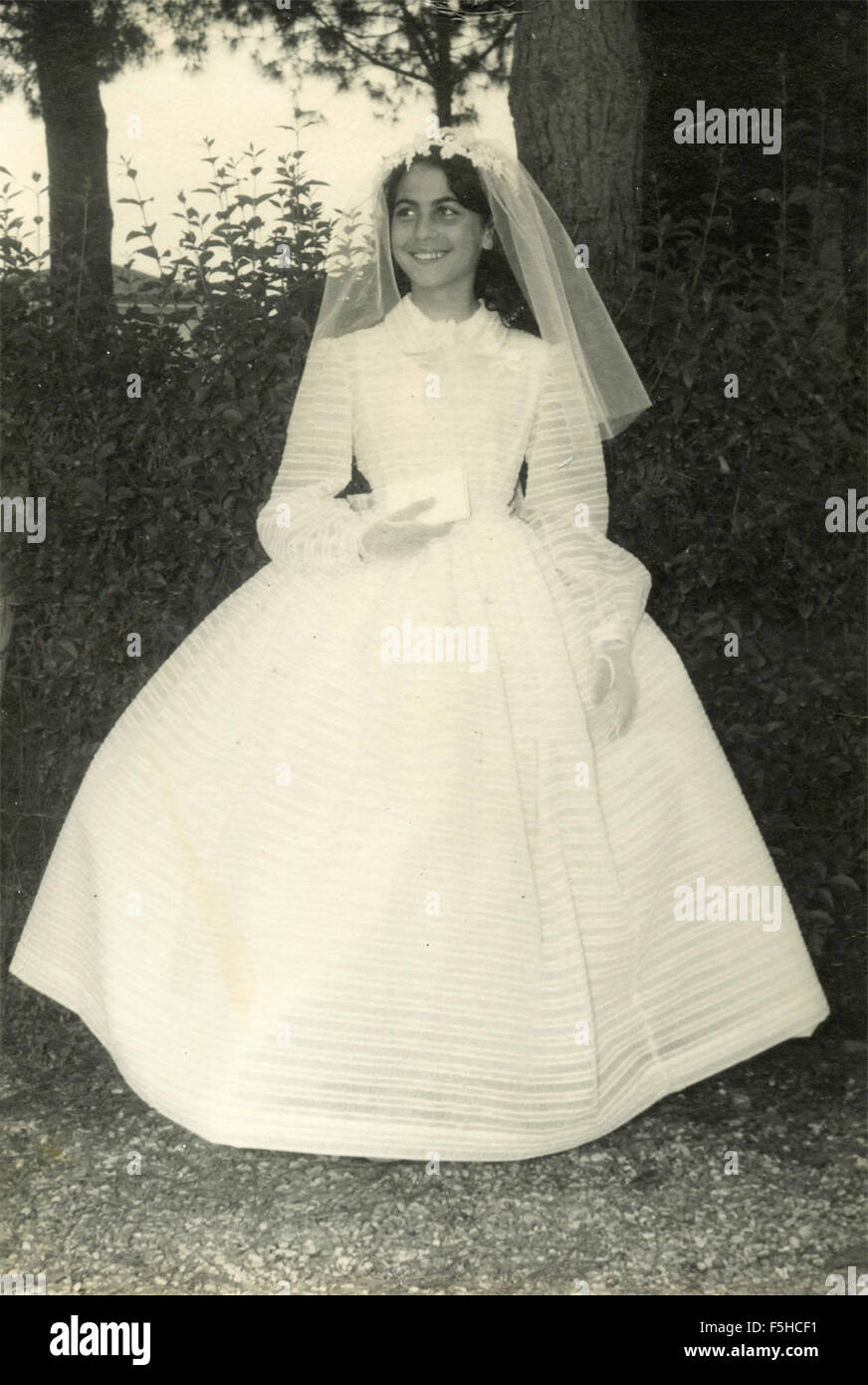 A little girl with white dress ceremonial, Italy Stock Photo