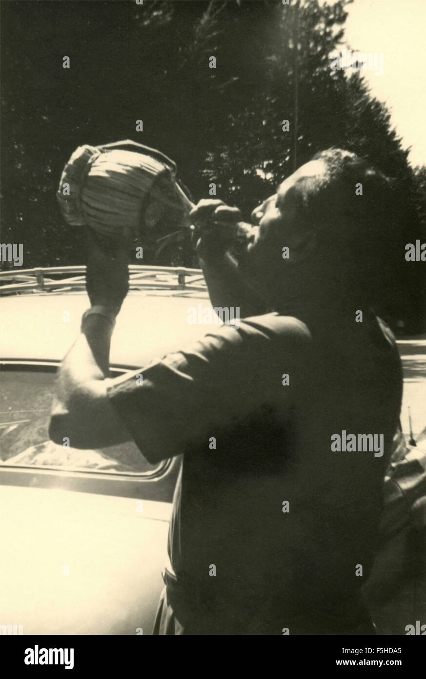 A man drinking from a flask, Italy Stock Photo Alamy