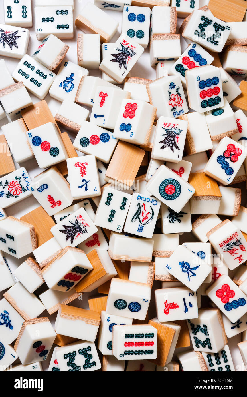 Mah-Jong gambling game. Looking down on various randomly scattered tiles, or cards used for playing the game. Stock Photo