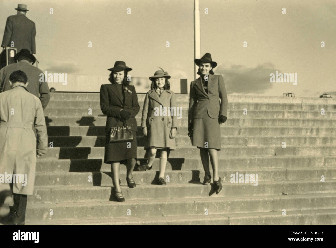 Two women and a little girl with hats, Italy Stock Photo