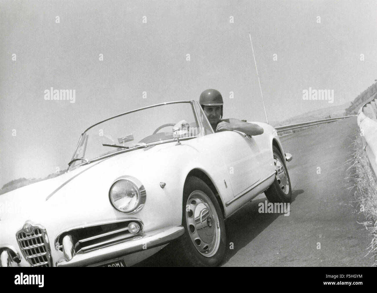 A guy with a white Alfa Romeo Giulietta Stock Photo