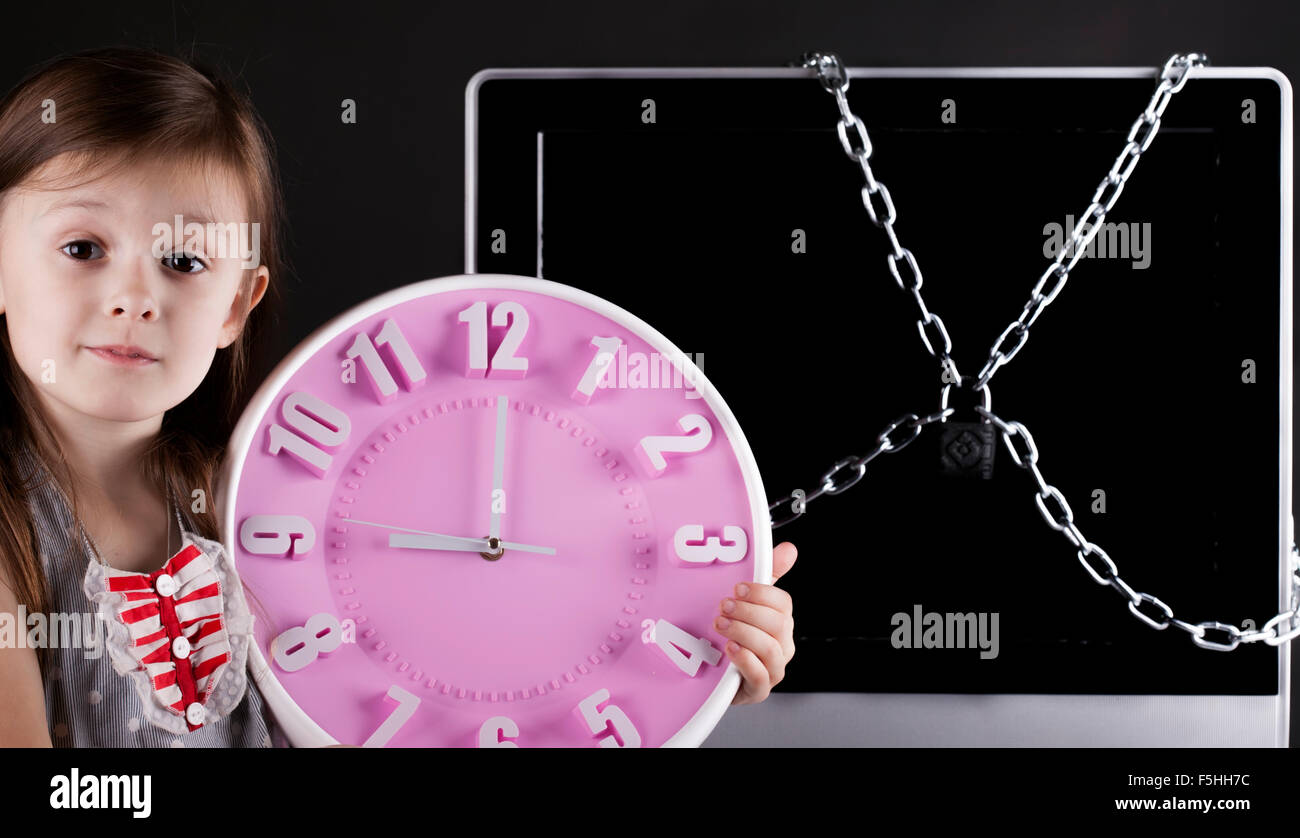 Young girl, TV closed with chain lock, clock Stock Photo