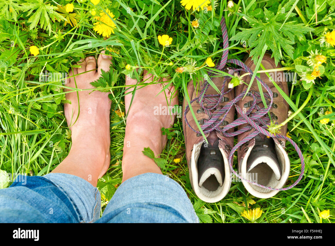 Man standing barefoot in the grass Stock Photo