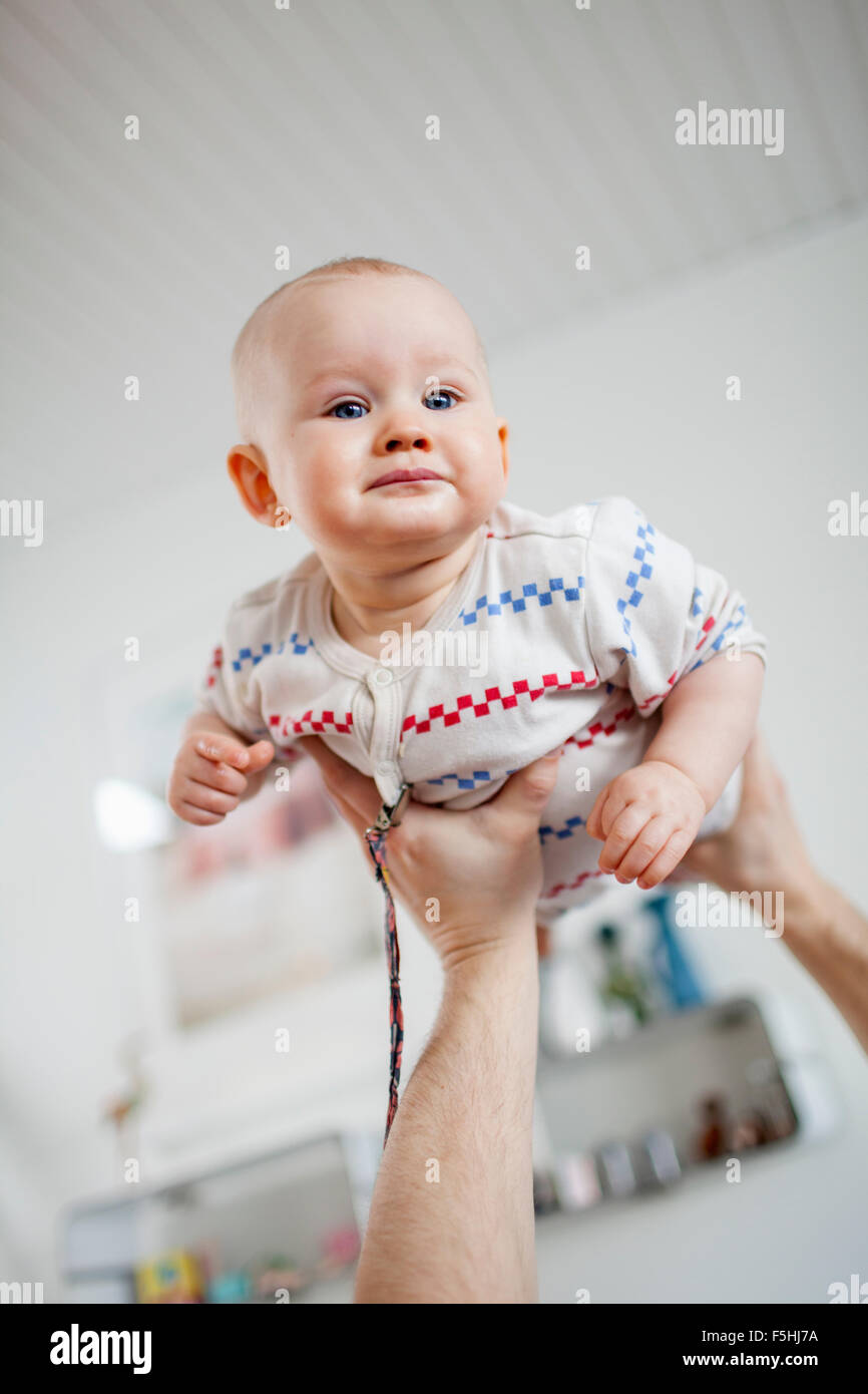 Sweden, Man holding baby son (2-5 months) in hands Stock Photo