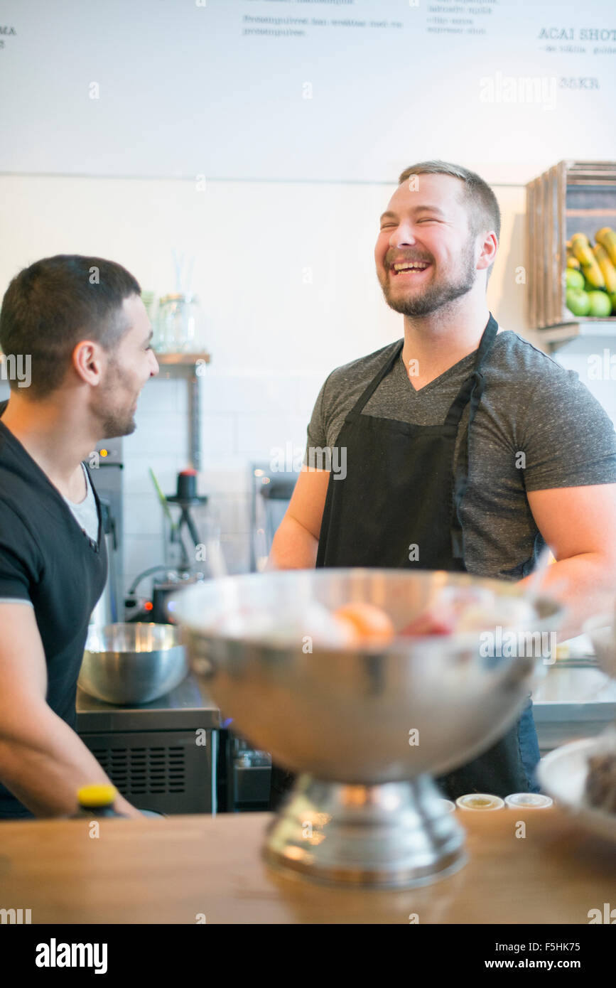 Sweden, Two men working in cafe Stock Photo