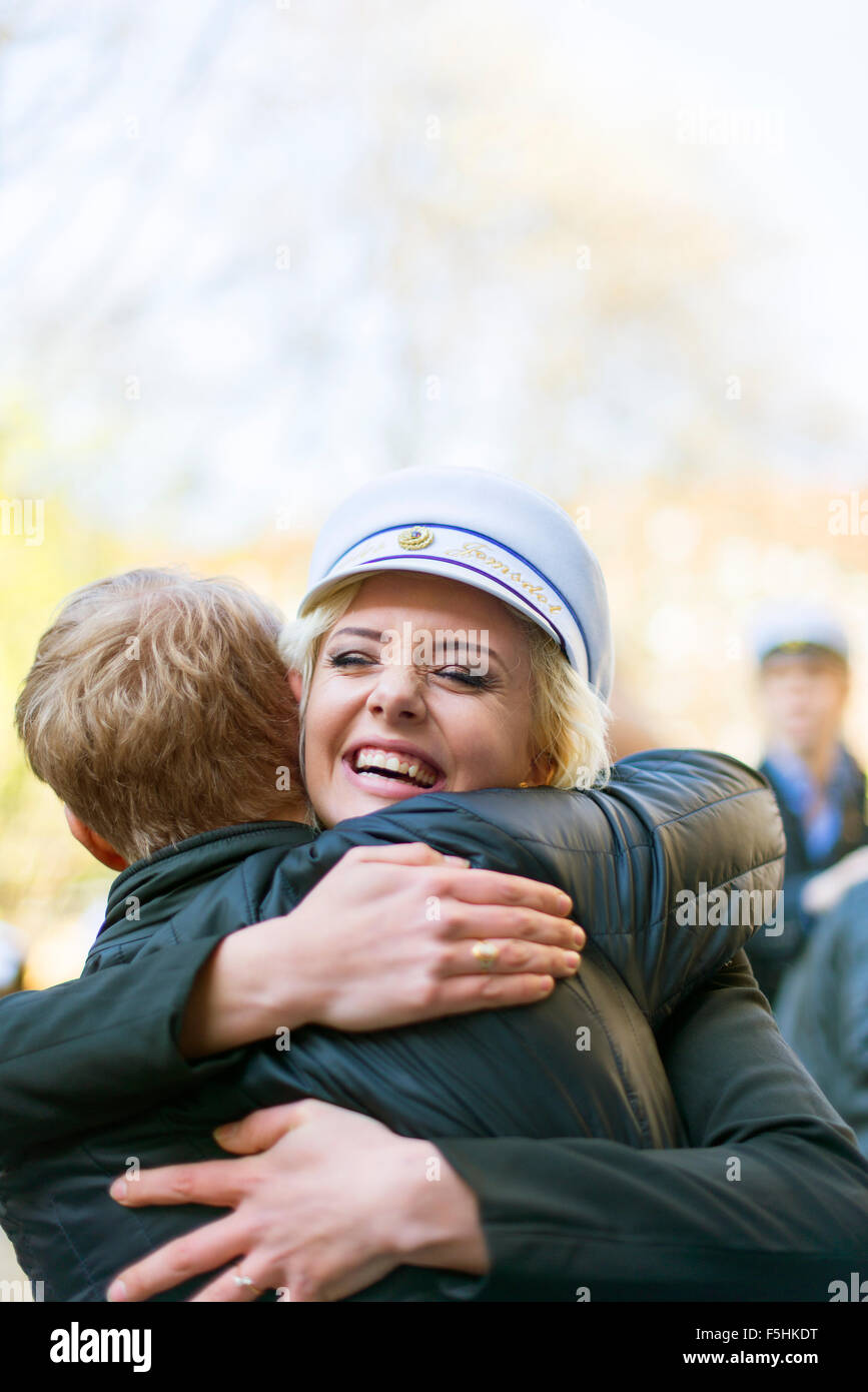 Sweden, Uppland, Stockholm, Young woman in traditional cap celebrating last day of high school Stock Photo