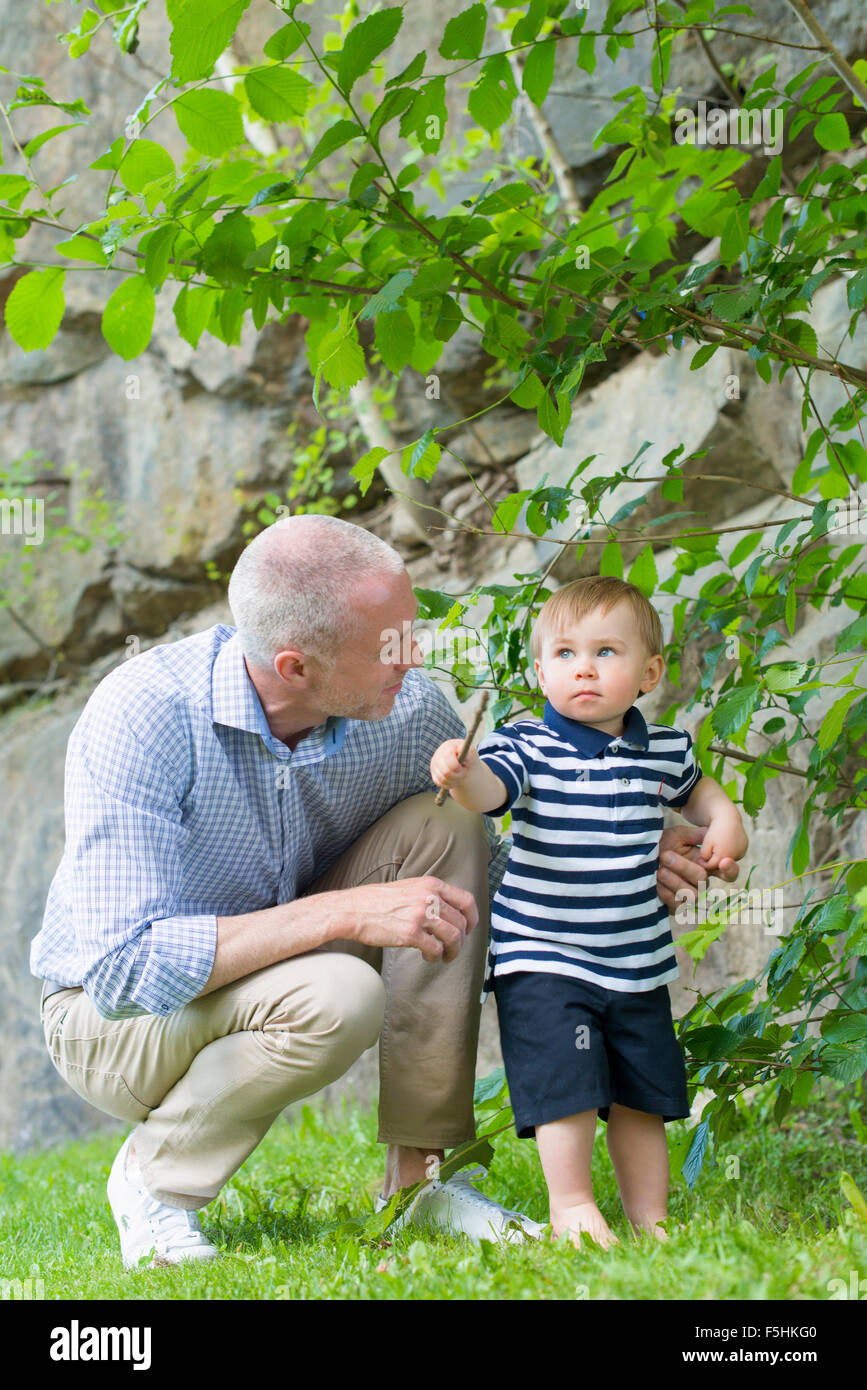 Sweden, Sodermanland, Nacka, Finnboda Hamn, Father and son (18-23 months) in park Stock Photo