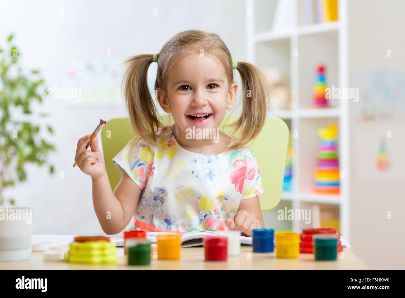 kid playing and painting at home or kindergarten or playschool Stock Photo