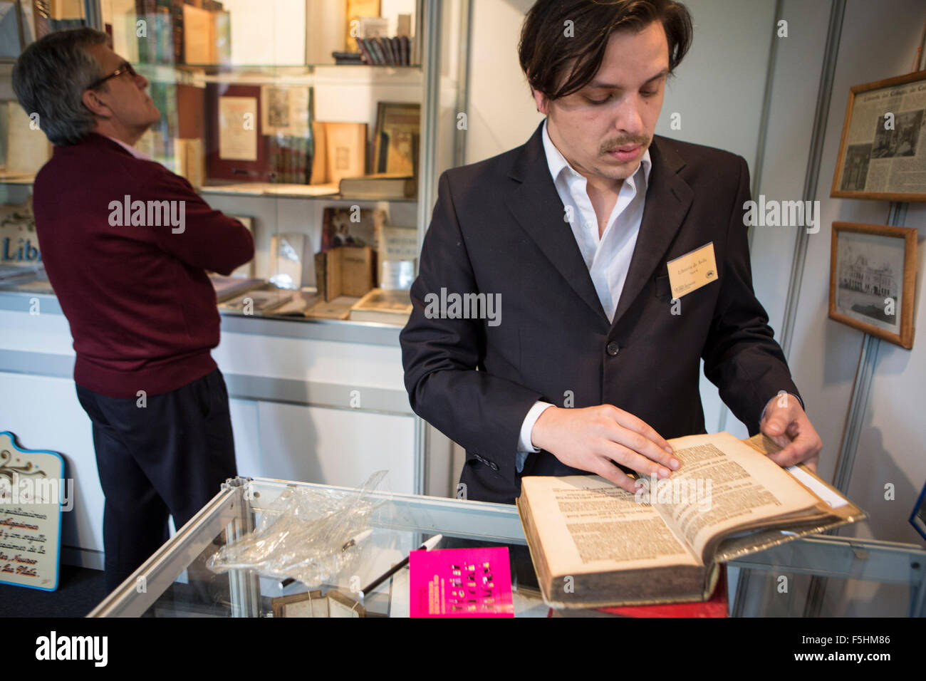 (151105) -- BUENOS AIRES, Nov. 5, 2015 (Xinhua) -- An exhibitor reads a German book of ophthalmology of 1687, during the 9th Ancient Book Fair, in Buenos Aires, capital of Argentina, on Nov. 4, 2015. According to local press, the fair organized by the Antiquarian Booksellers Association gathered books of the 15th century as well as engravings, maps, ancient photographs and posters. (Xinhua/Martin Zabala) Stock Photo