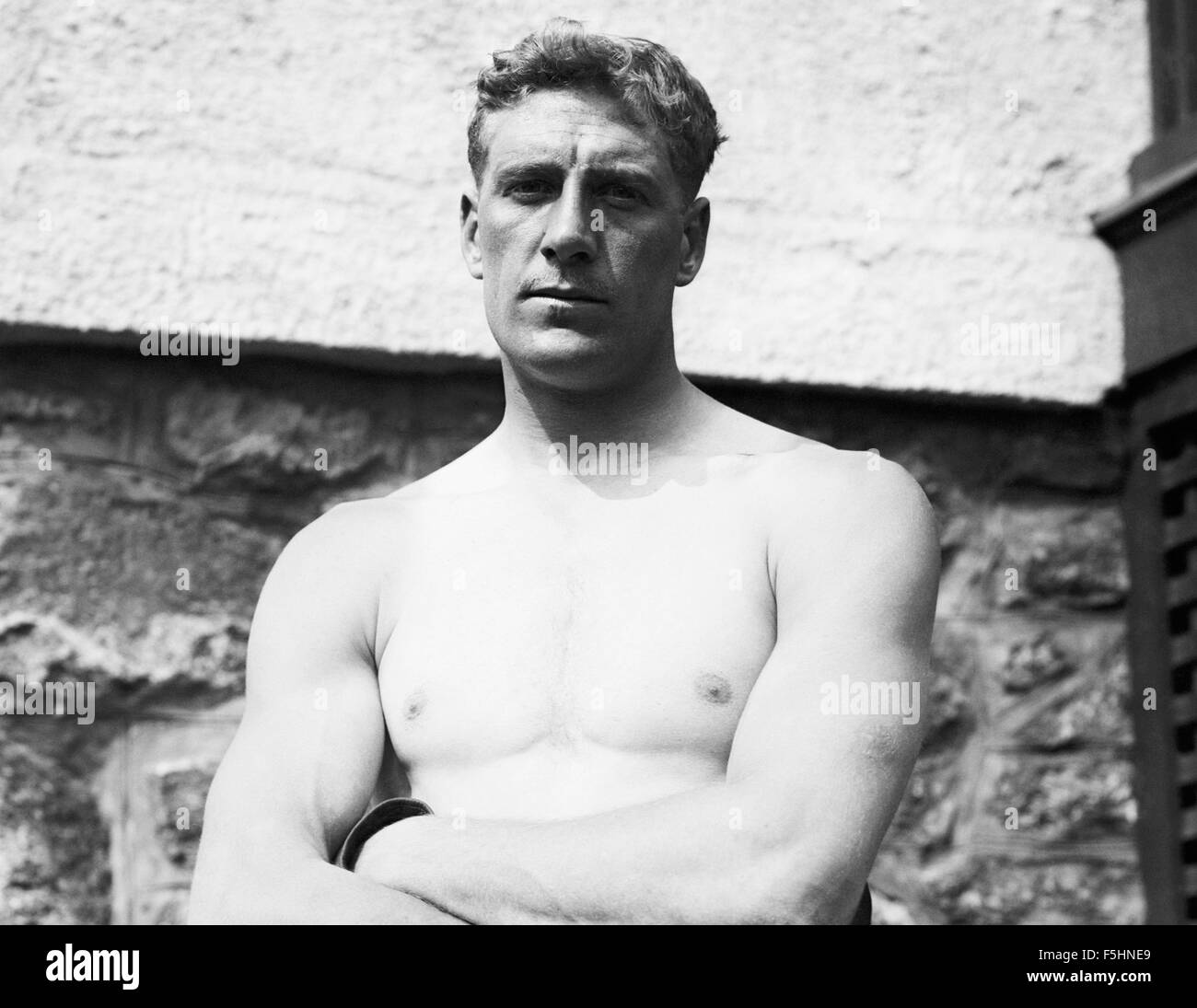 Vintage photo of English heavyweight boxer Bombardier Billy Wells (1889 - 1967). Wells, from the East End of London, was British and British Empire Heavyweight Champion from 1911 to 1919. He was also famous for being an early Rank 'gongman' - the person seen striking the large gong at the beginning of Rank Organisation films. Stock Photo