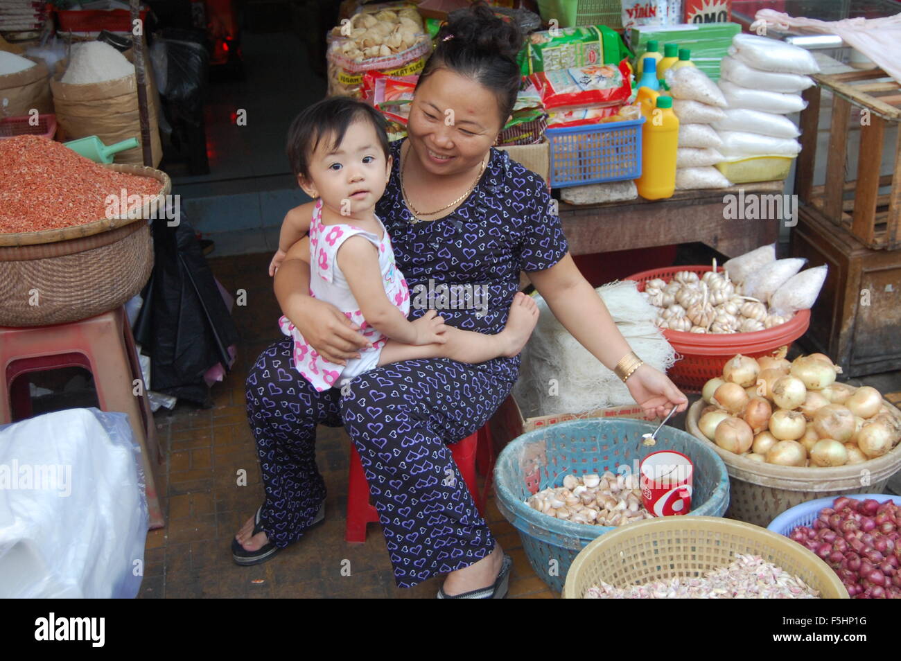 Woman and baby in Vietnamese market Stock Photo