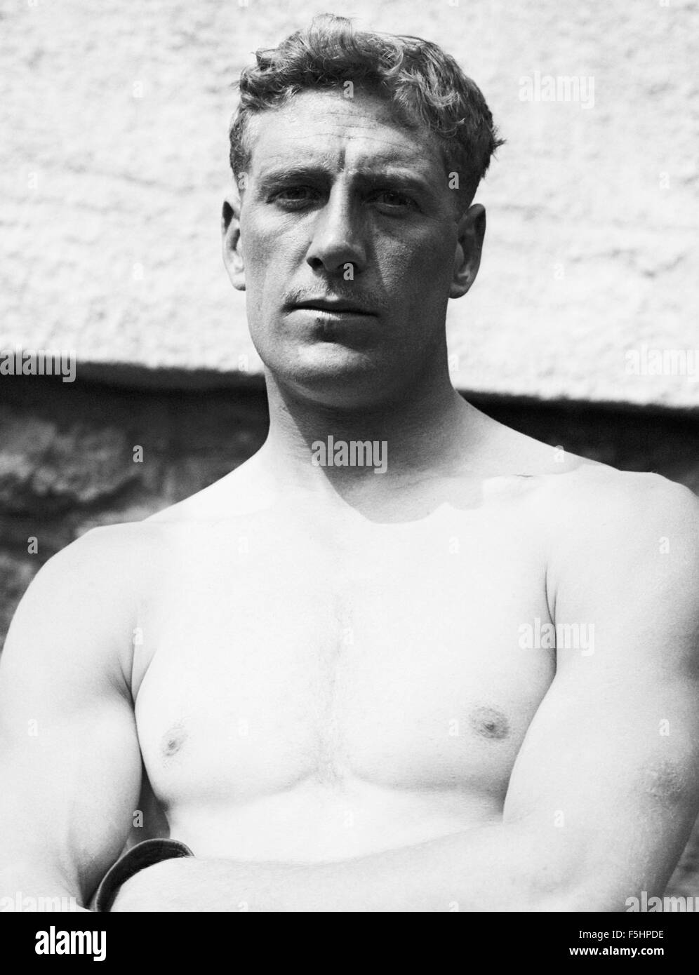 Vintage photo of English heavyweight boxer Bombardier Billy Wells (1889 - 1967). Wells, from the East End of London, was British and British Empire Heavyweight Champion from 1911 to 1919. He was also famous for being an early Rank 'gongman' - the person seen striking the large gong at the beginning of Rank Organisation films. Stock Photo
