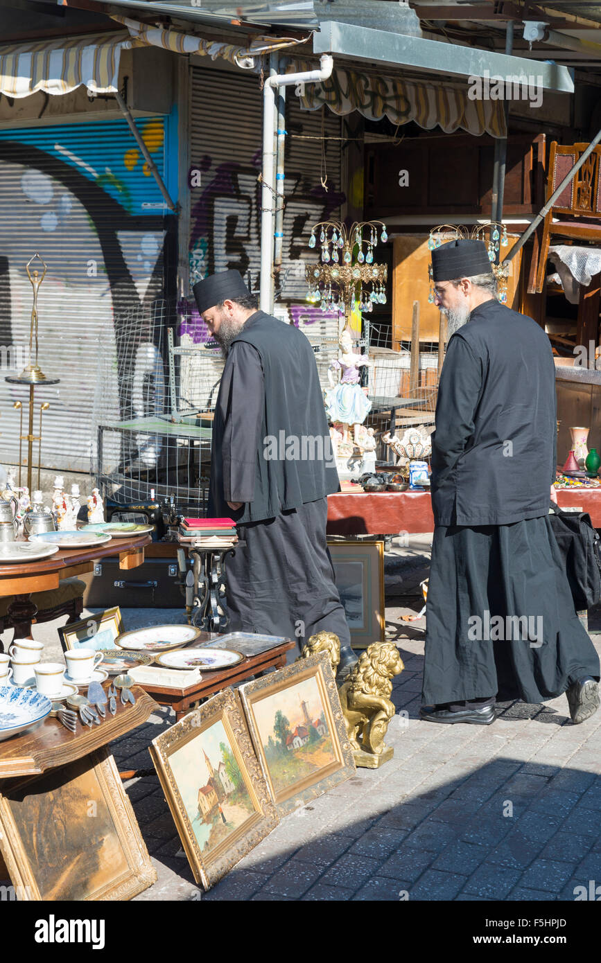ATHENS, GREECE - OCTOBER 27, 2015: Flea market at Avissinias Square. Two Orthodox priests to bargain hunting Stock Photo