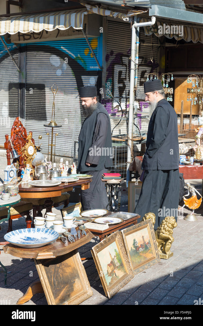 ATHENS, GREECE - OCTOBER 27, 2015: Flea market at Avissinias Square. Two Orthodox priests to bargain hunting Stock Photo