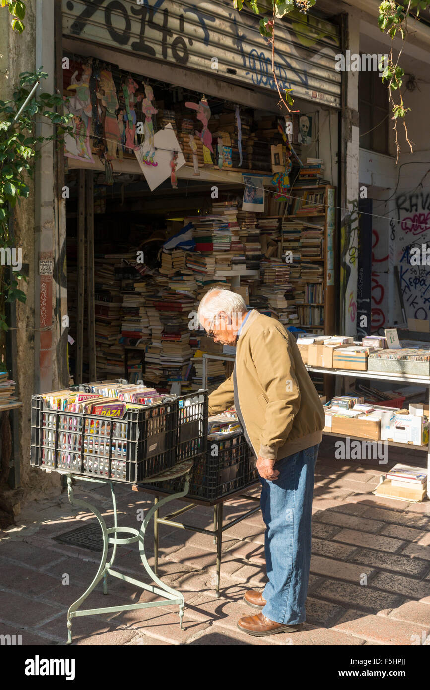 ATHENS, GREECE - OCTOBER 27, 2015: Thrift stores in the Plaka district. A man searches the CD Stock Photo