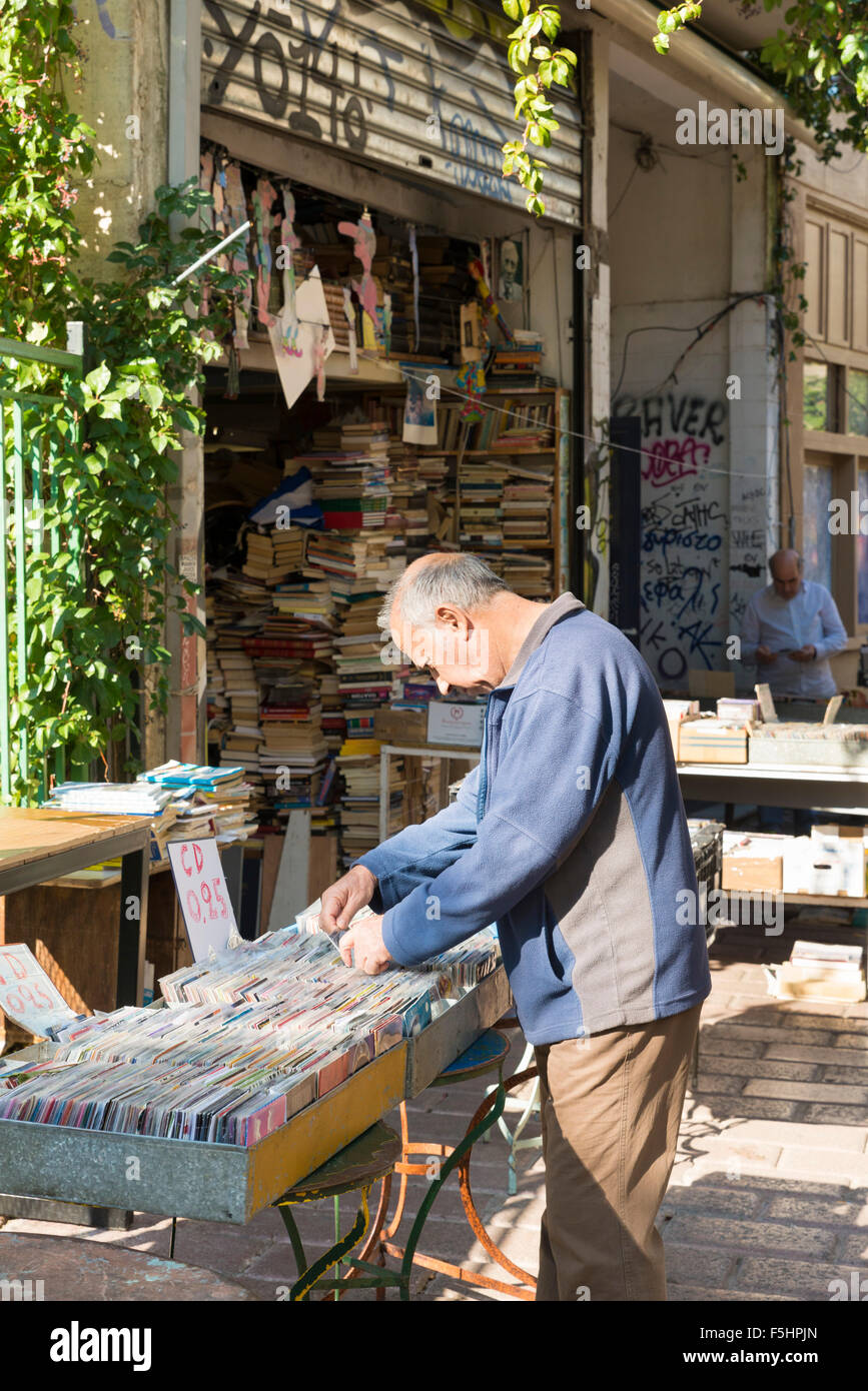 ATHENS, GREECE - OCTOBER 27, 2015: Thrift stores in the Plaka district. A man searches the CD Stock Photo