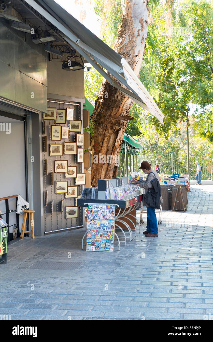 ATHENS, GREECE - OCTOBER 27, 2015: Thrift stores in the Plaka district. A man searches the DVD Stock Photo