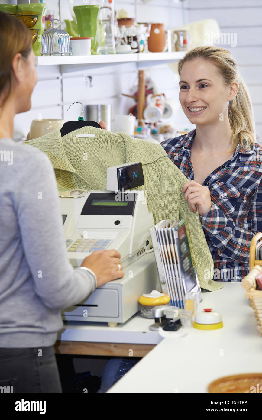 Customer Buying Clothing In Charity Shop Stock Photo Alamy