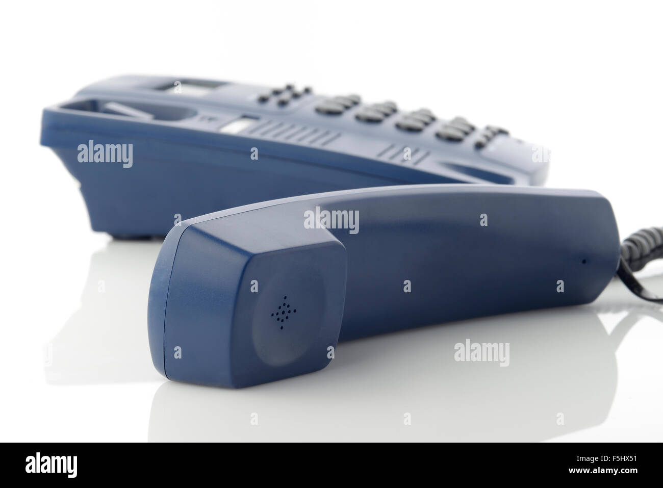 Receiver of Blue Telephone over white background shot in studio Stock Photo