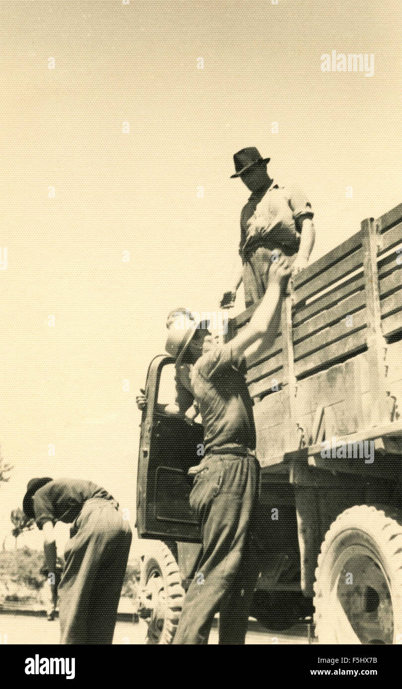 Workers load a truck, Italy Stock Photo - Alamy