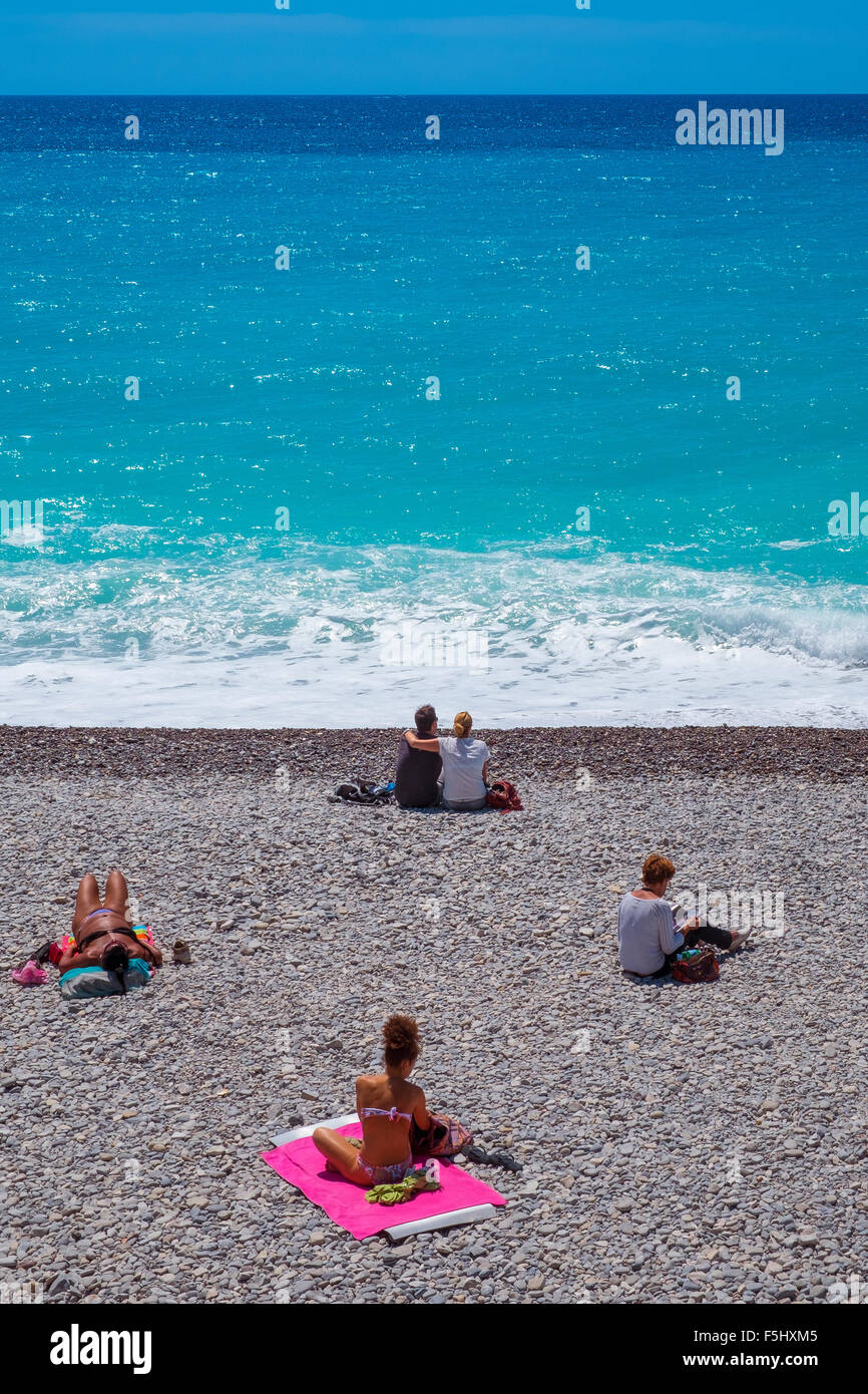 people sunbathing lying stony beach sun sea sand Stock Photo