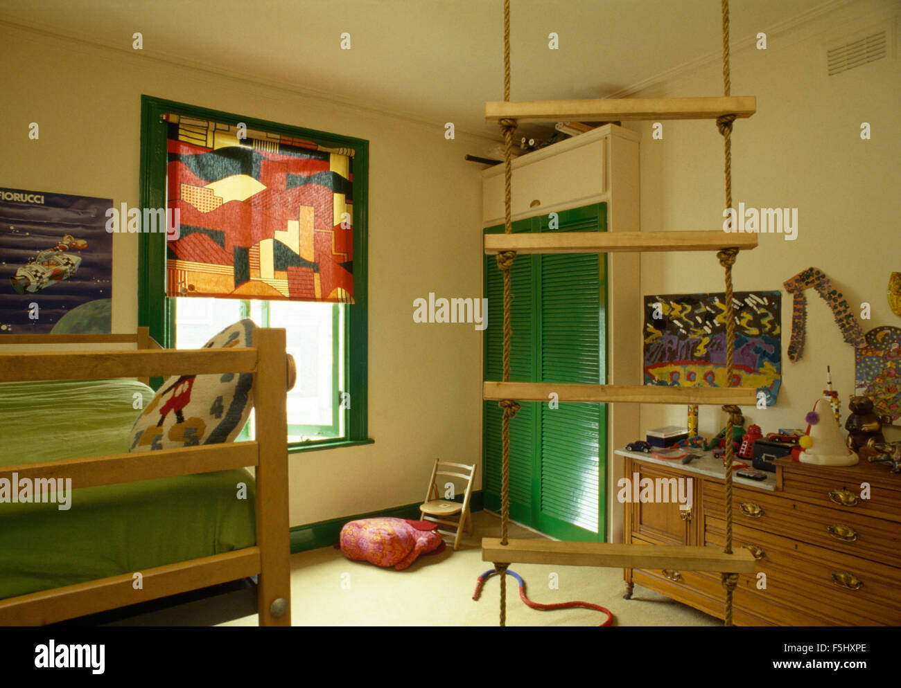 Rope ladder and vibrant patterned blind in children's seventies bedroom ...
