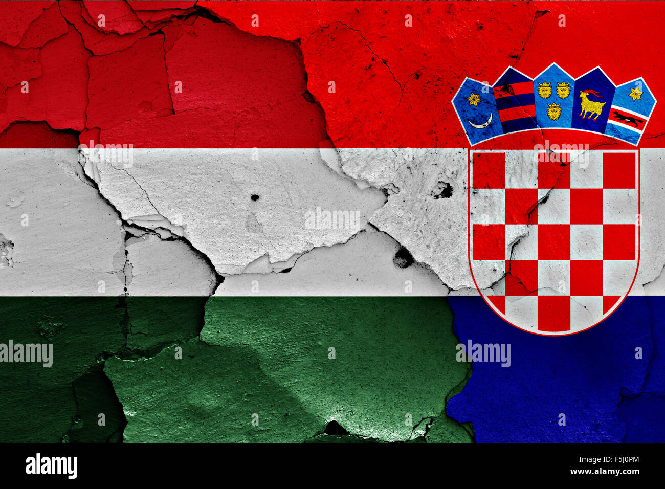 flags of Hungary and Croatia painted on cracked wall Stock Photo