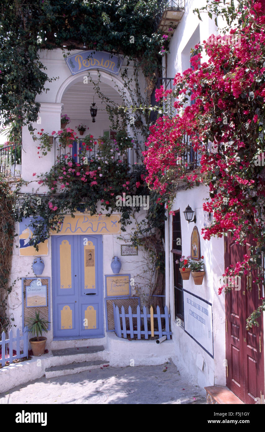 Exterior of a traditional white Spanish villa with pink bougainvillea on the walls Stock Photo