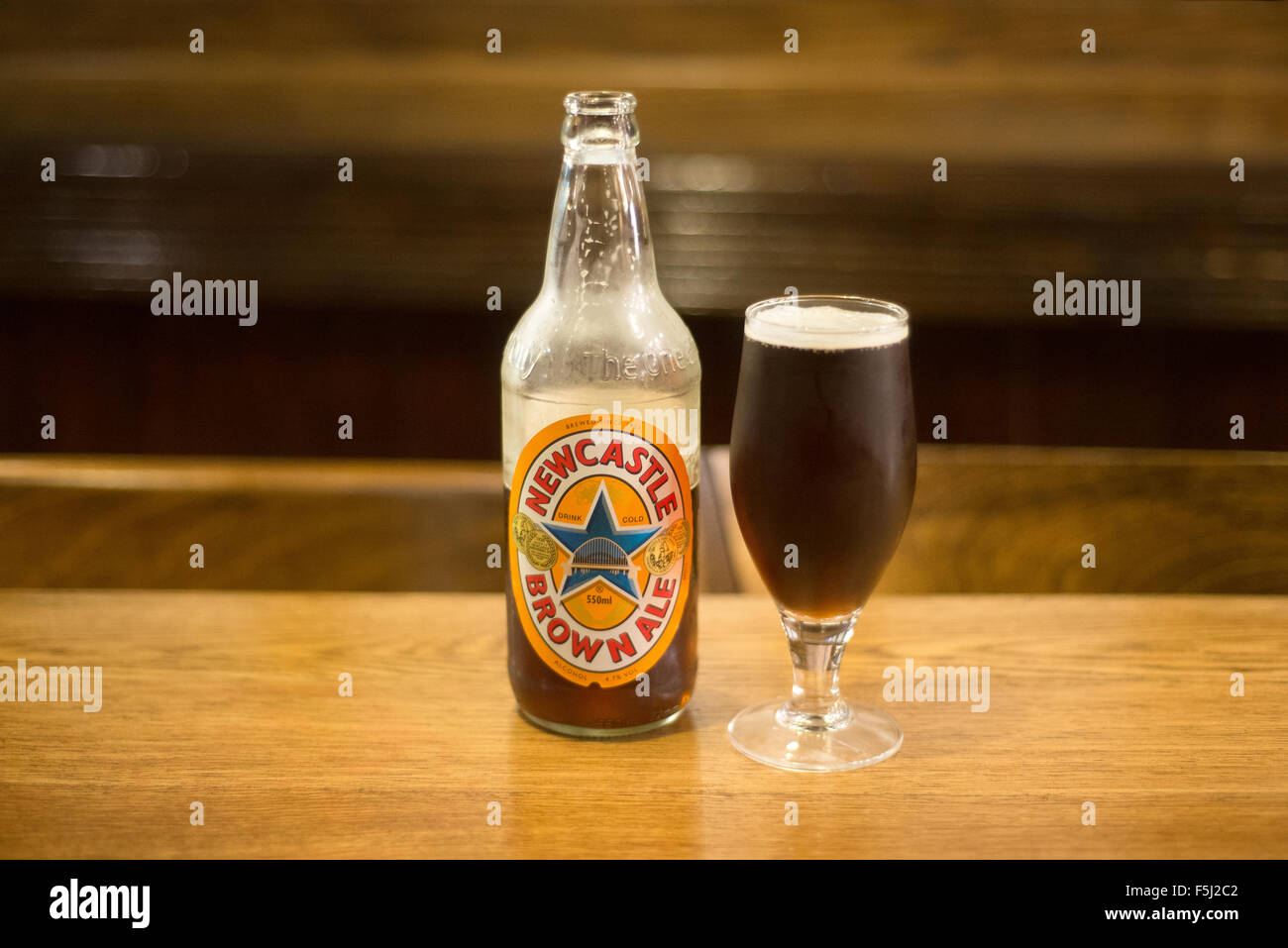 A bottle and glass of Newcastle Brown Ale in a pub in Newcastle Upon Tyne, England, UK Stock