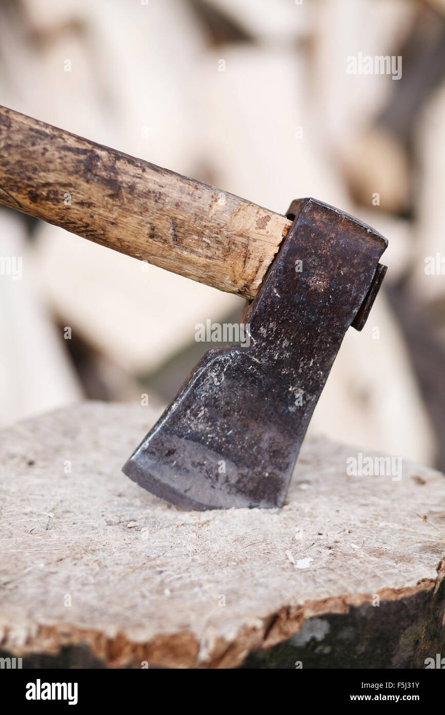 Axe stuck in a stump Stock Photo