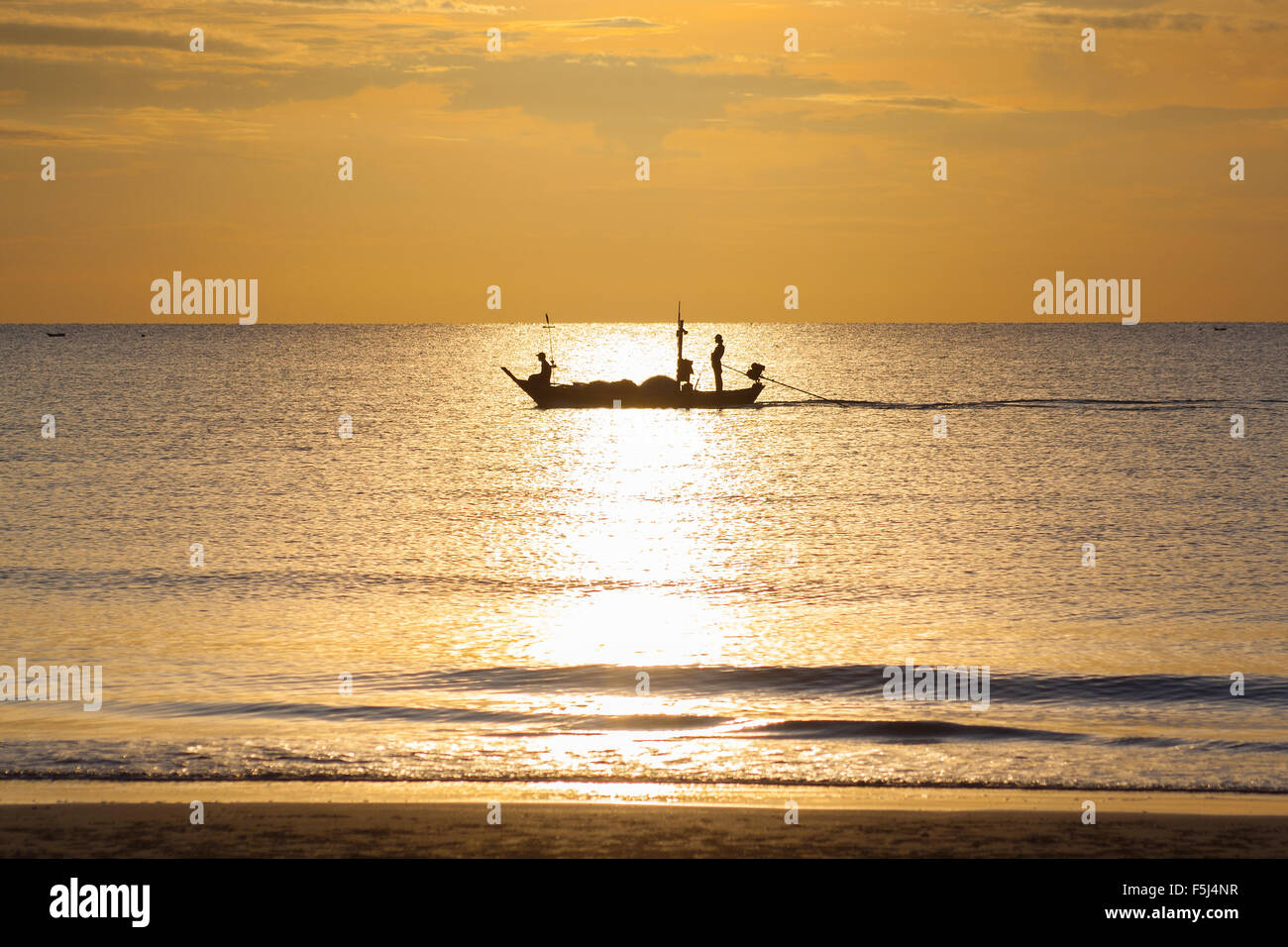 Silhouette of Thai Fishing Boat on sunrise Stock Photo