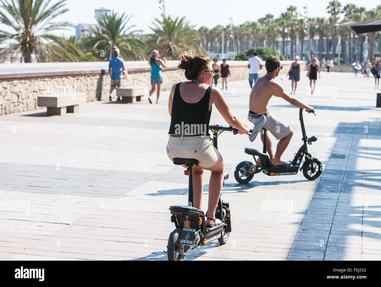 Electric battery powered bikes along promenade at Barceloneta Beach,urban beach in Barcelona,Catalonia,Spain. Stock Photo
