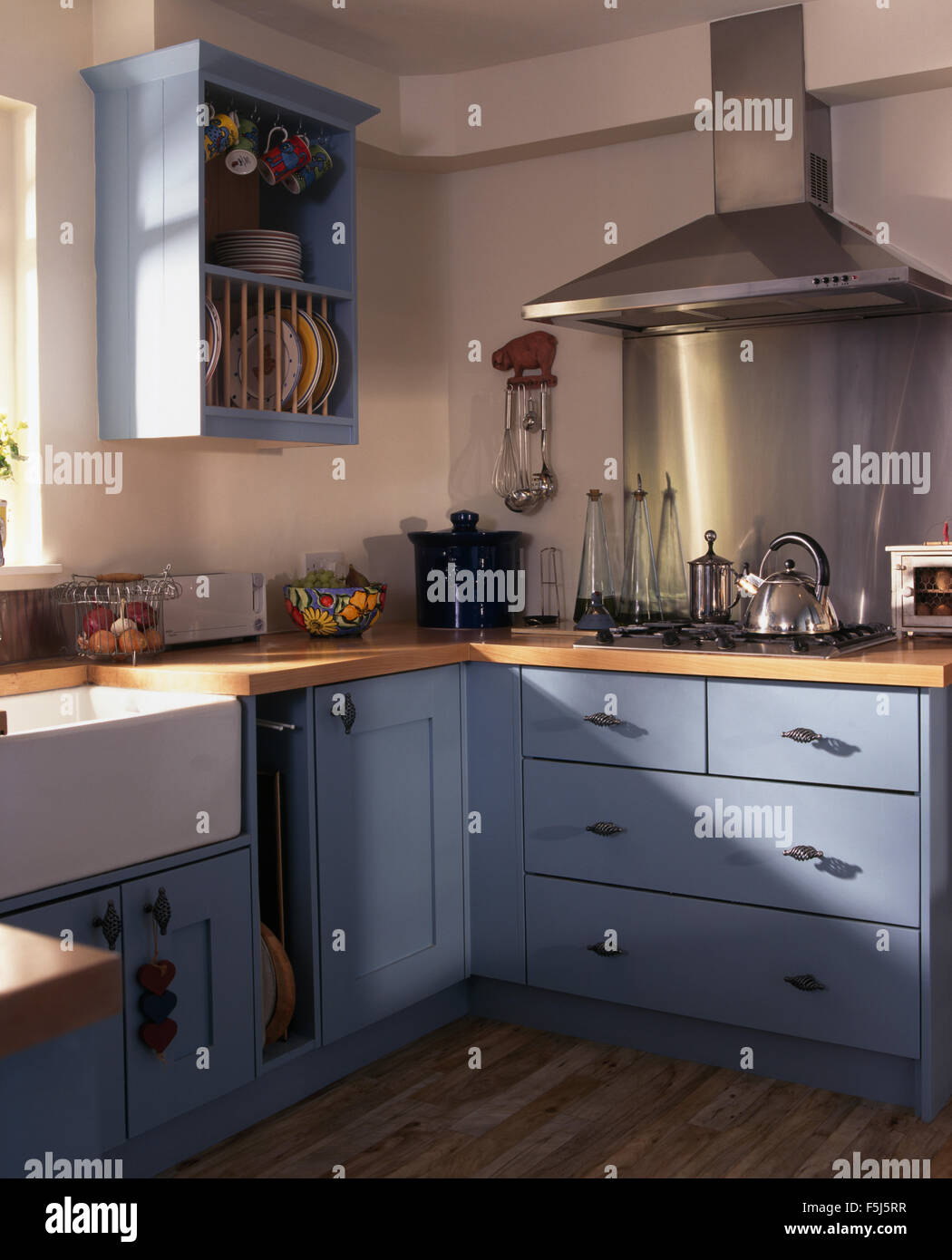 Stainless steel extractor and splashback above the hob in a kitchen