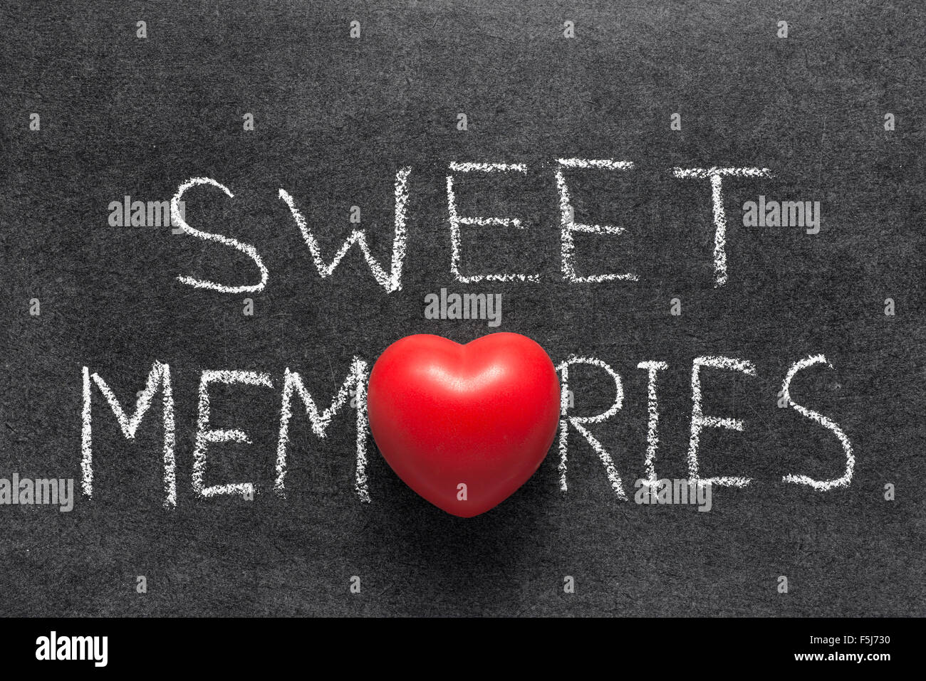 sweet memories phrase handwritten on chalkboard with red heart used instead of O Stock Photo