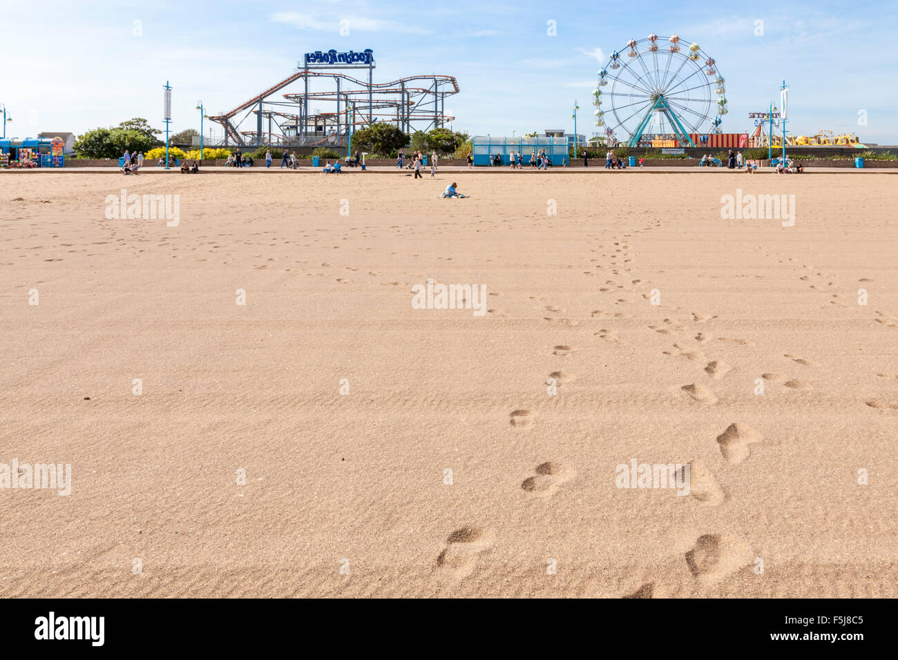 Footprints on the beach leading to the Pleasure Beach fairground at Skegness, Lincolnshire, England, UK Stock Photo