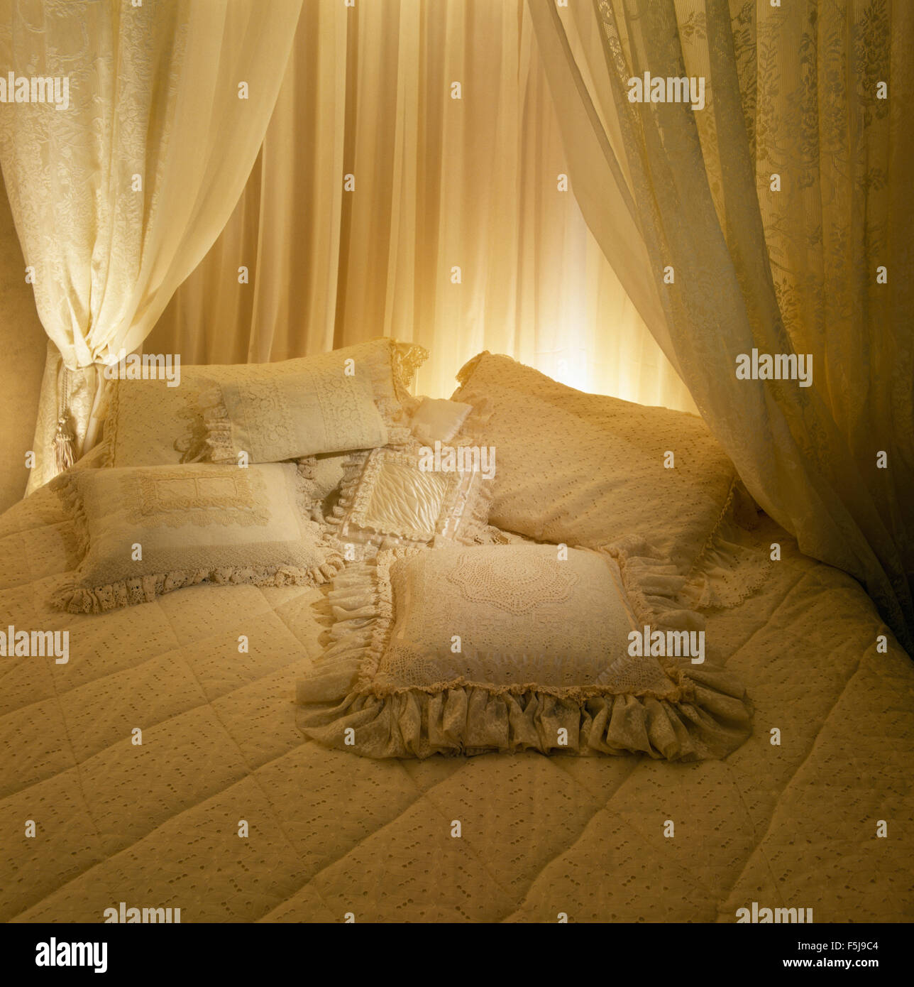 Cream Drapes Around Bed With Co Ordinating Cushions In An Eighties